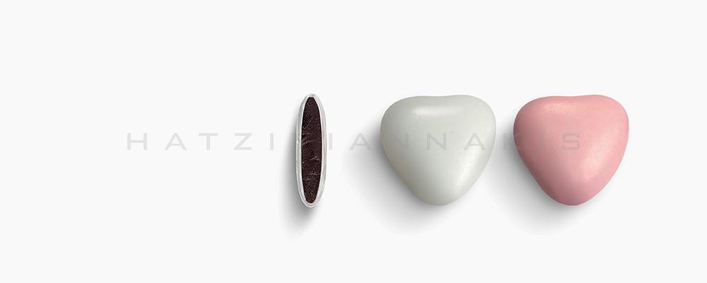Κουφέτα Χατζηγιαννάκη Σοκολάτας Καρδιά μεσαία 1201_300 λευκό - ροζ ματ - συσκευασία ενός κιλού 1kg - για τις μπομπονιέρες του γάμου σας ή της βάπτισης του παιδιού σας